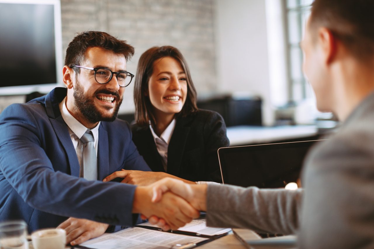 Young Business Couple Make A Deal And Shake Hands 1